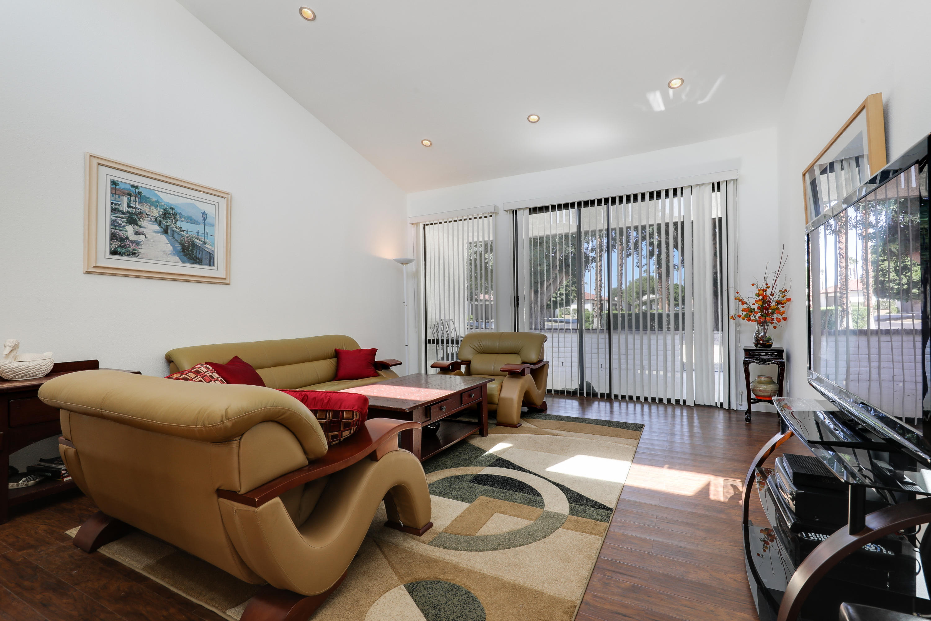 4 Leon Way Rancho Mirage, CA 92270 - Photo 8 of 20 a living room with furniture and a floor to ceiling window