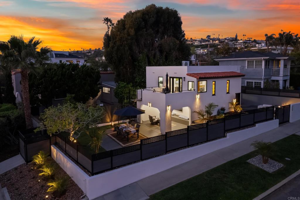 a view of a chairs and tables in the back yard of the house