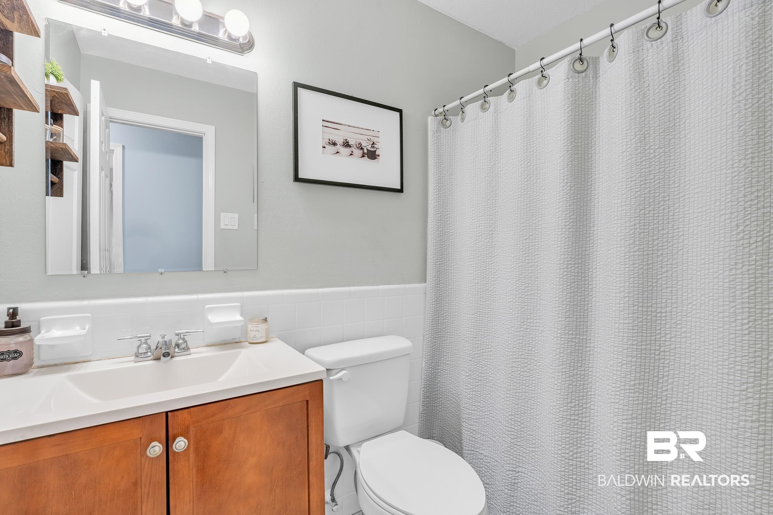 206 West Jackson Avenue Summerdale, AL 36580 - Photo 19 of 37 Bathroom featuring toilet, tile walls, a wainscoted wall, and vanity