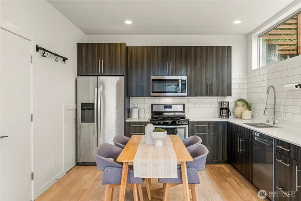 a kitchen with wooden cabinets and stainless steel appliances