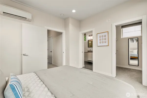 a bedroom with a bed and painting on the wall