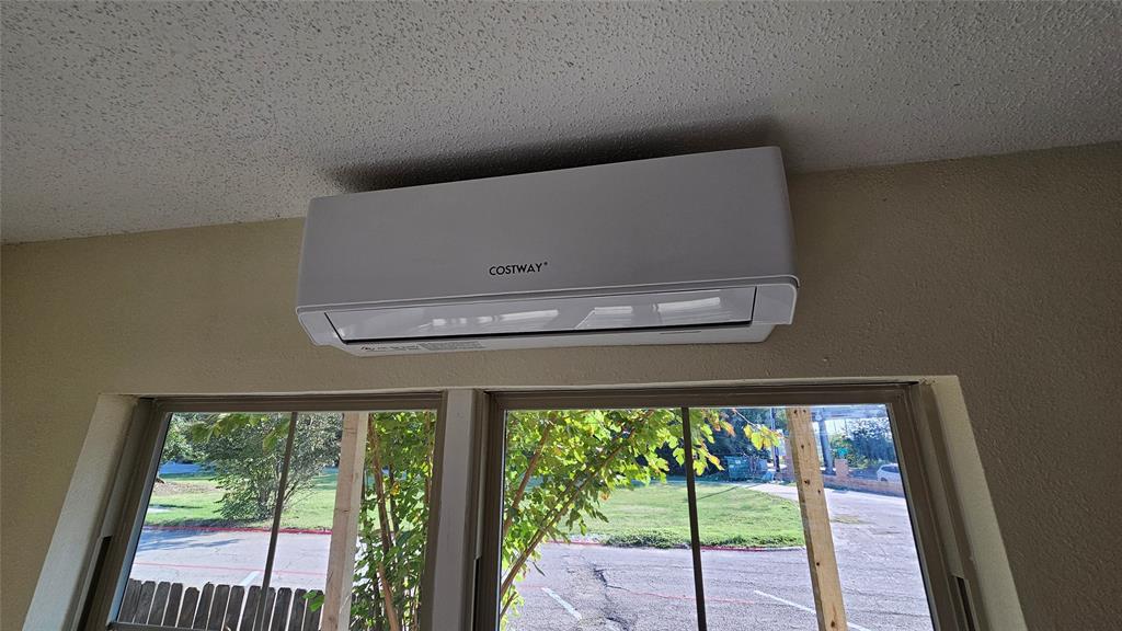 5065 Ridglea Lane, Unit 1009 Fort Worth, TX 76116 - Photo 11 of 12 a view of a living room with a floor to ceiling window