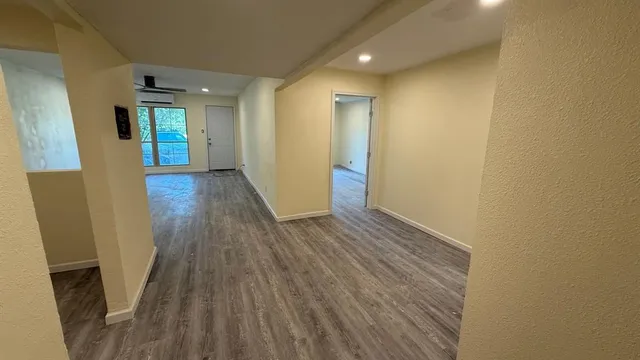 a view of hallway with wooden floor