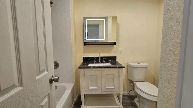 a white toilet sitting next to a bathroom sink