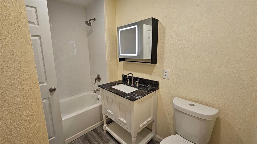 5065 Ridglea Lane, Unit 1009 Fort Worth, TX 76116 - Photo 8 of 12 a bathroom with a sink toilet and shower