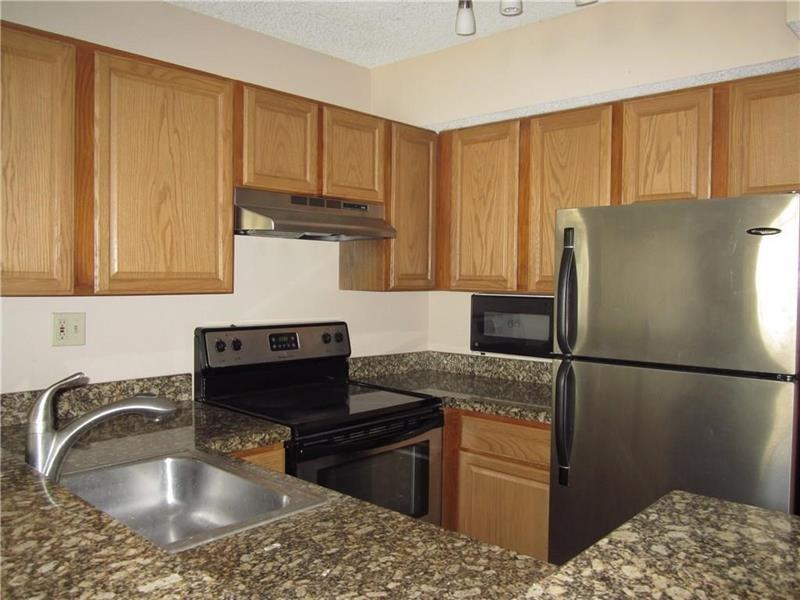 751 Lyons Road, Unit 18102 Coconut Creek, FL 33063 - Photo 1 of 9 a kitchen with stainless steel appliances granite countertop a refrigerator sink and cabinets