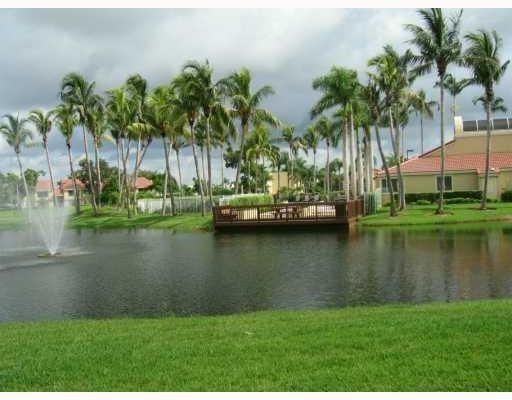 751 Lyons Road, Unit 18102 Coconut Creek, FL 33063 - Photo 8 of 9 a view of a lake with a big yard