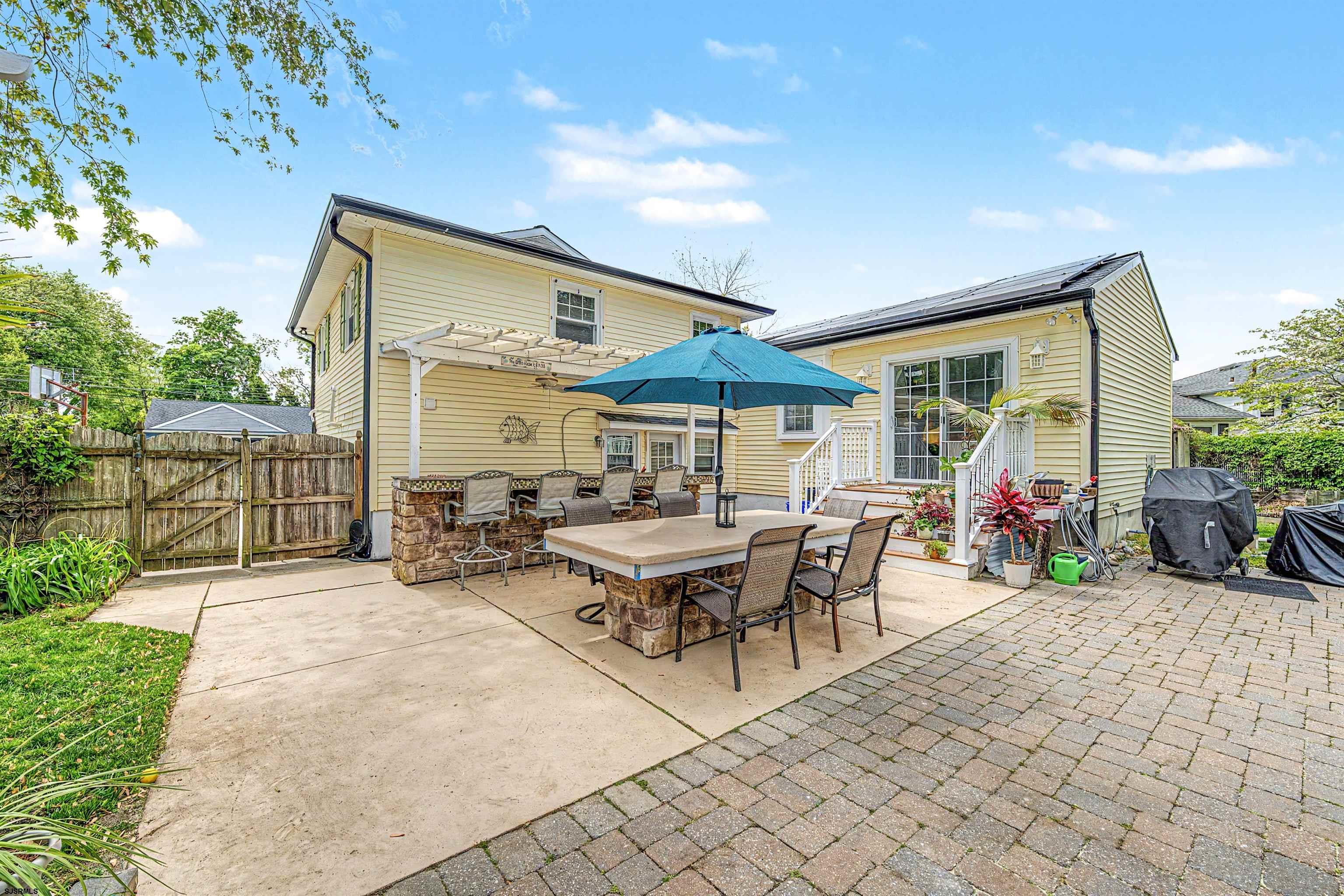 125 Exton Road Somers Point, NJ 08244 - Photo 26 of 35 a view of a patio with a table and chairs under an umbrella