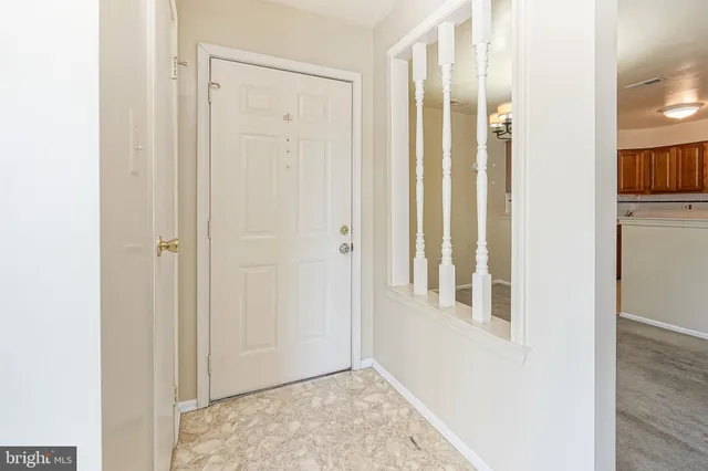a view of a livingroom with wooden floor and entryway