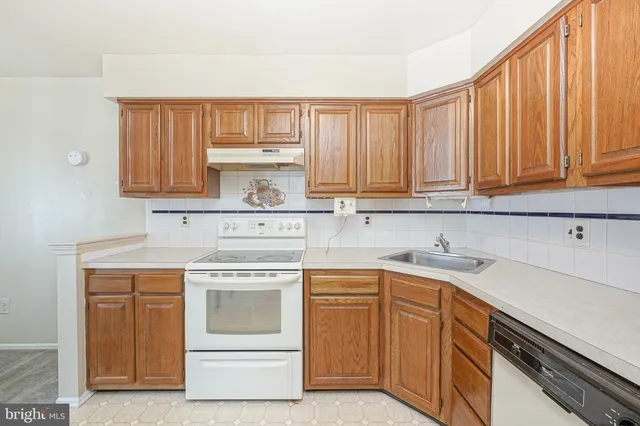 a kitchen with a stove top oven sink and cabinets