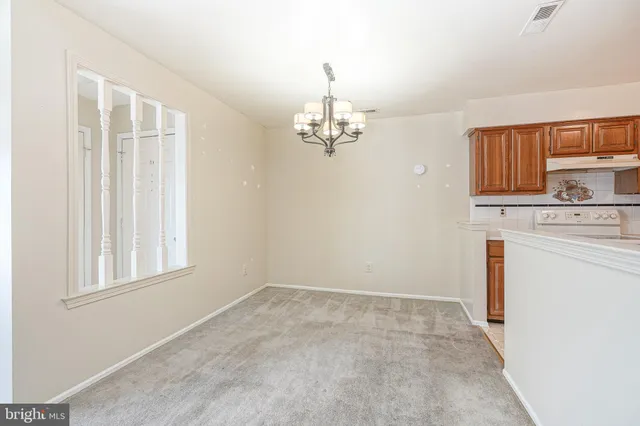 a view of a kitchen with an empty space and a window