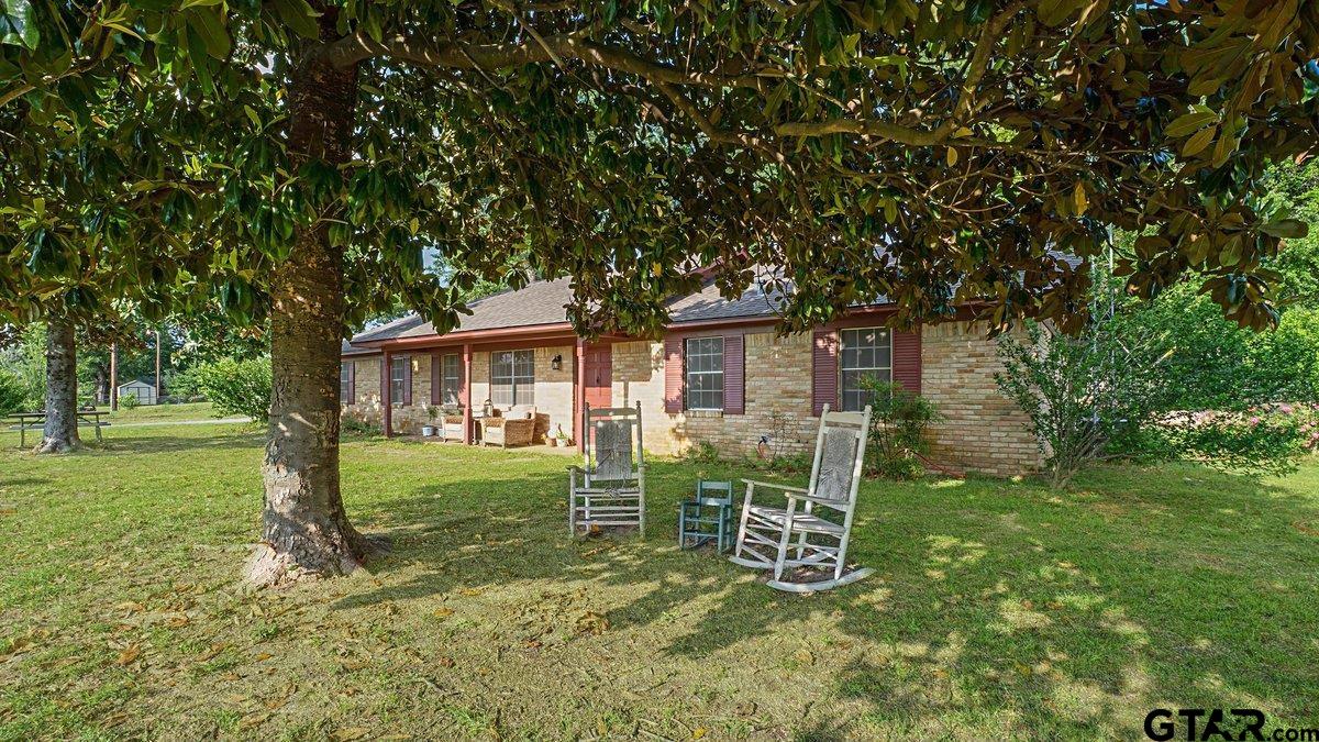 8192 County Road 428 Tyler, TX 75704 - Photo 3 of 38 a backyard of a house with table and chairs
