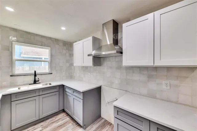a kitchen with granite countertop white cabinets and white appliances