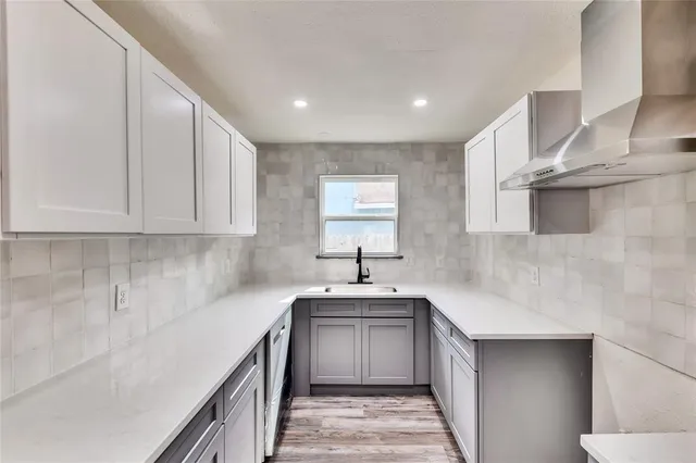 a kitchen with stainless steel appliances granite countertop a sink stove and cabinets