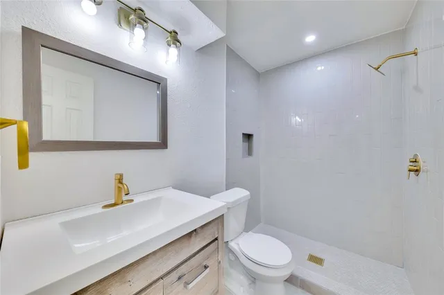 a bathroom with a sink a toilet and mirror