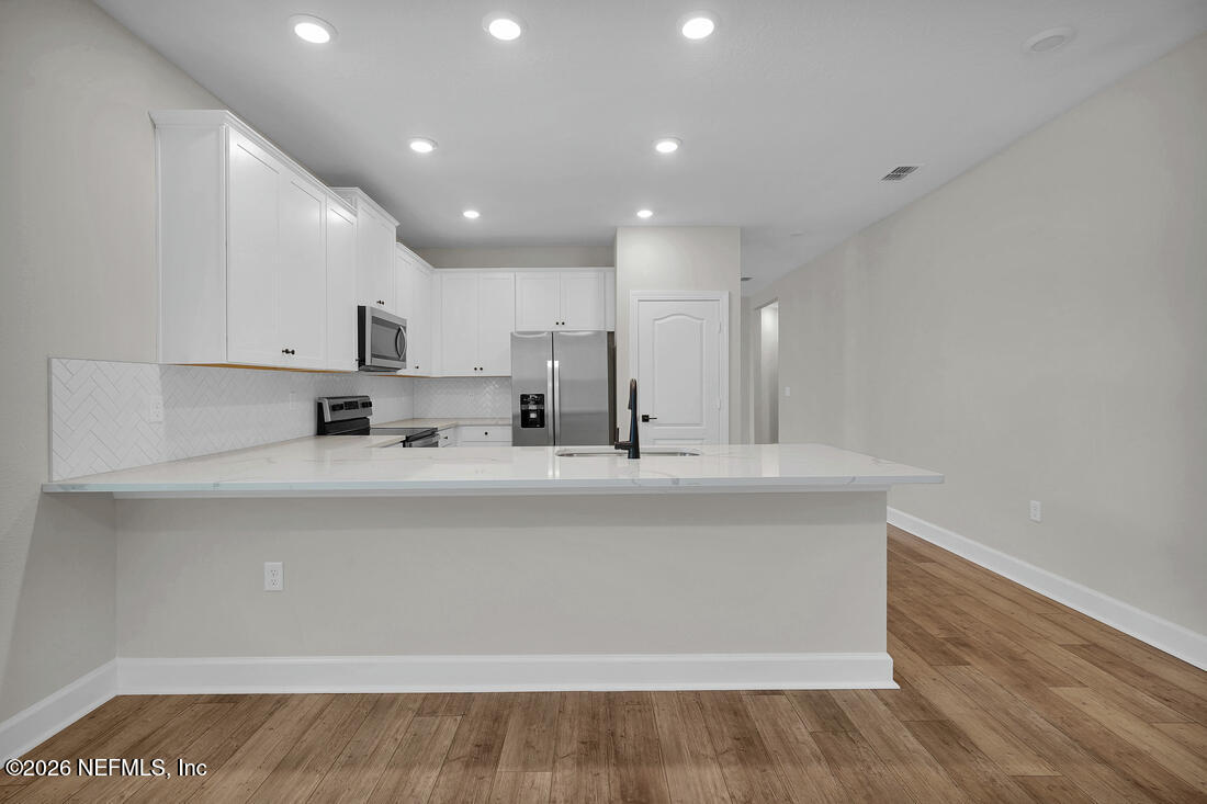 6970 Canoe Birch Road Jacksonville, FL 32219 - Photo 11 of 20 a view of kitchen with stainless steel appliances sink refrigerator and microwave