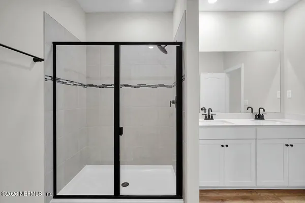 a bathroom with a shower and a sink