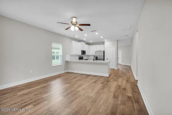 a view of a kitchen with wooden floor and a kitchen