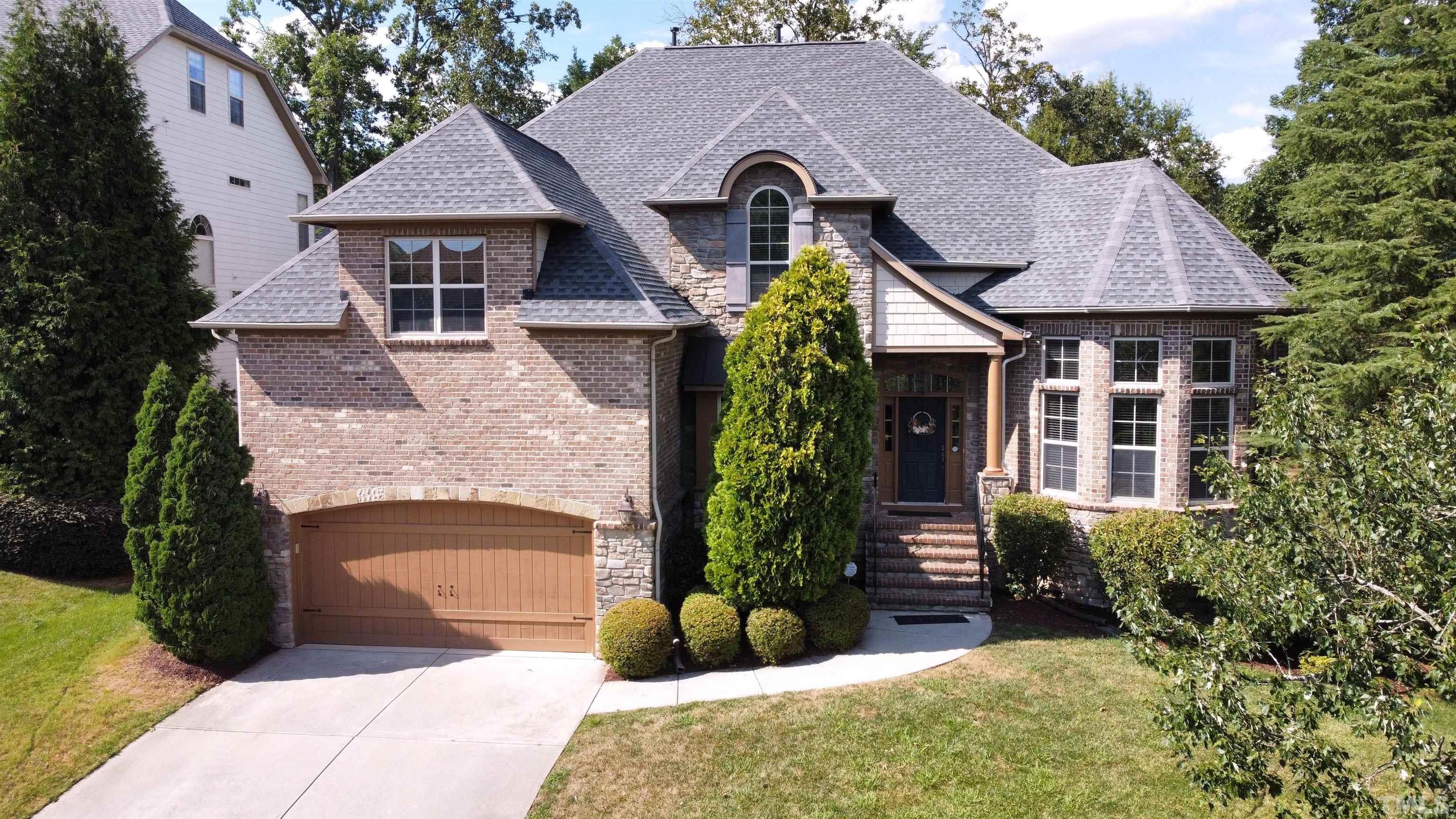 a front view of a house with a garden