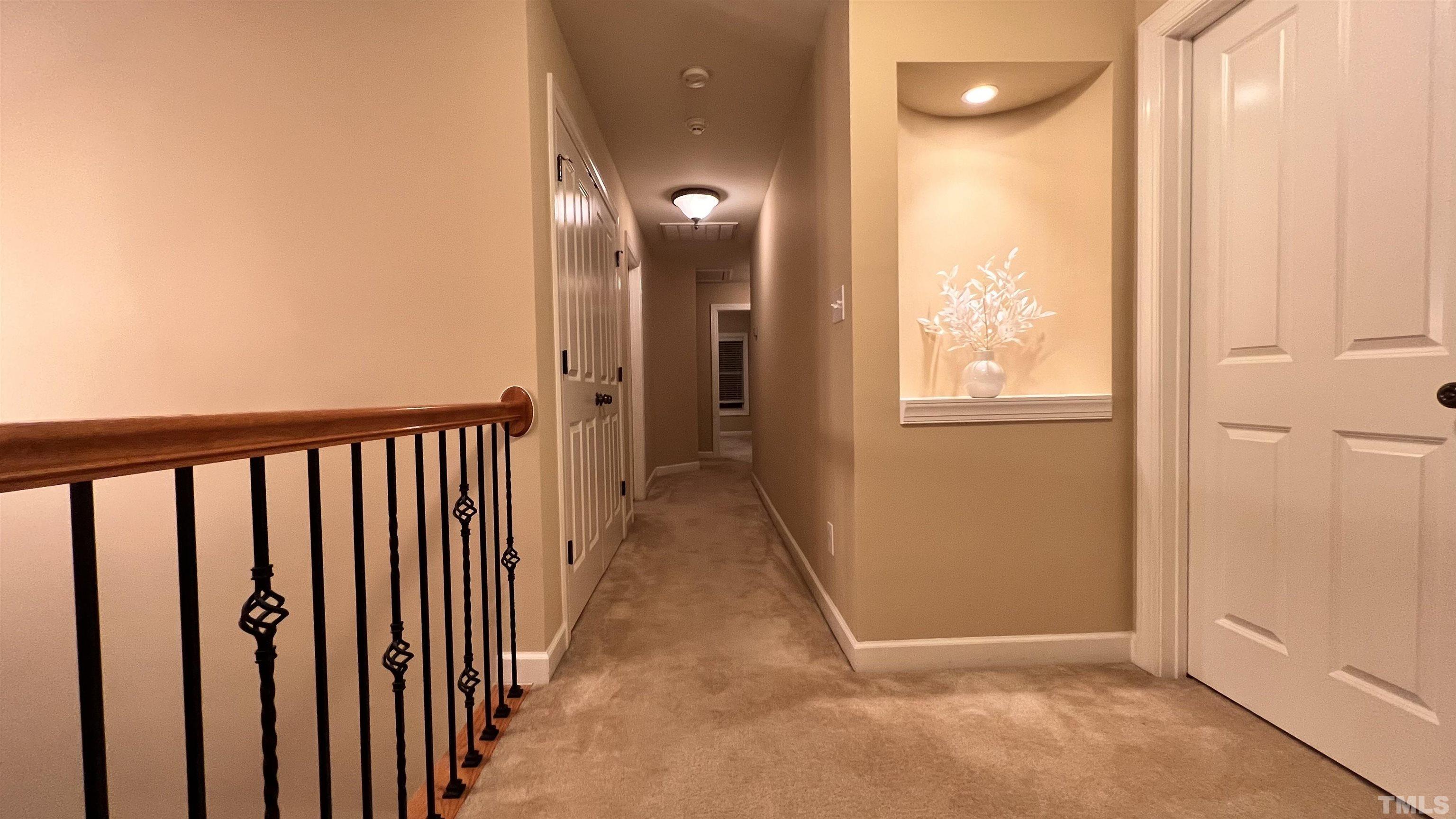 309 Parish House Road Cary, NC 27513 - Photo 12 of 33 a view of a hallway with wooden floor and a bathroom