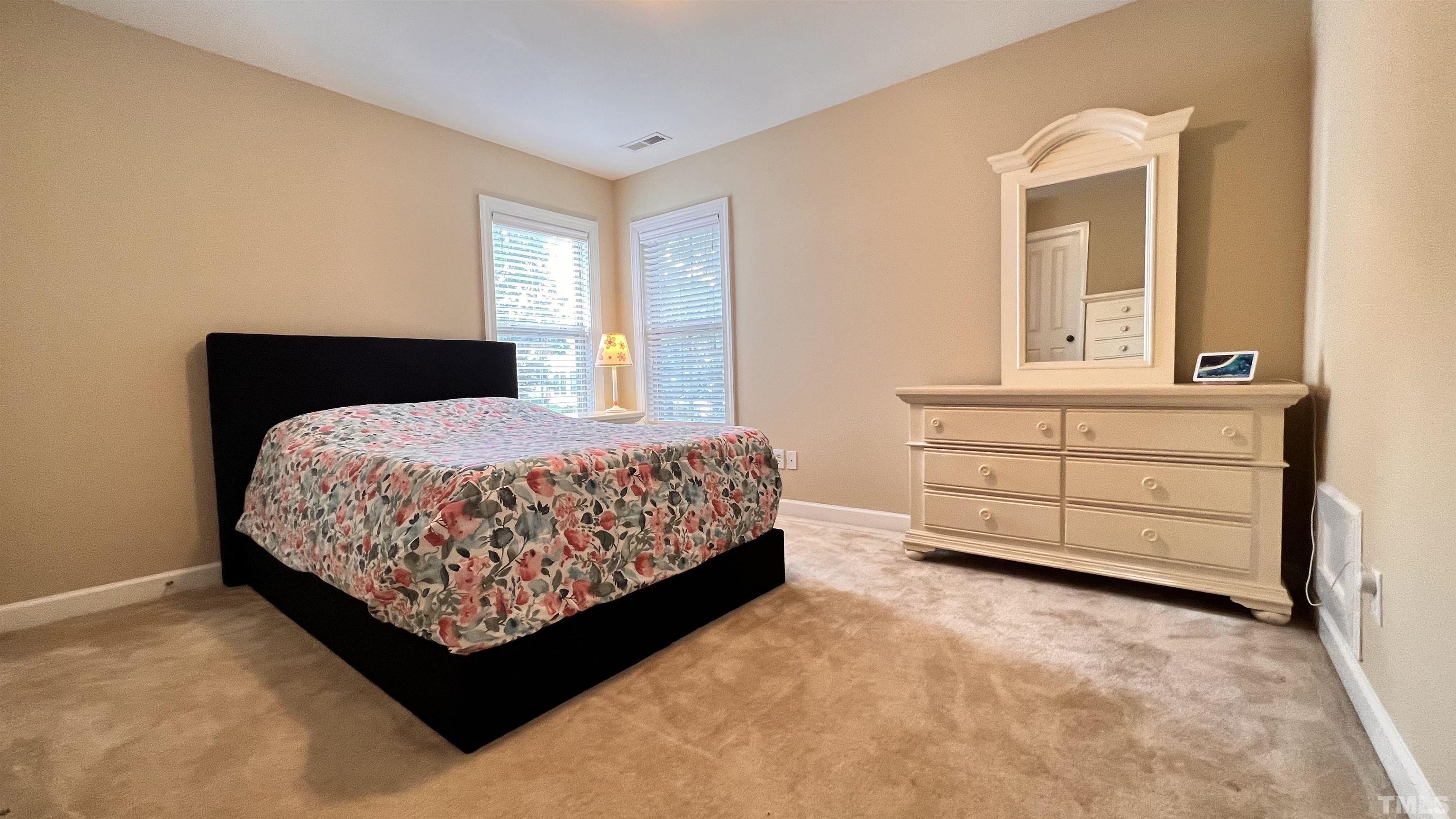309 Parish House Road Cary, NC 27513 - Photo 14 of 33 a bedroom with a bed and window