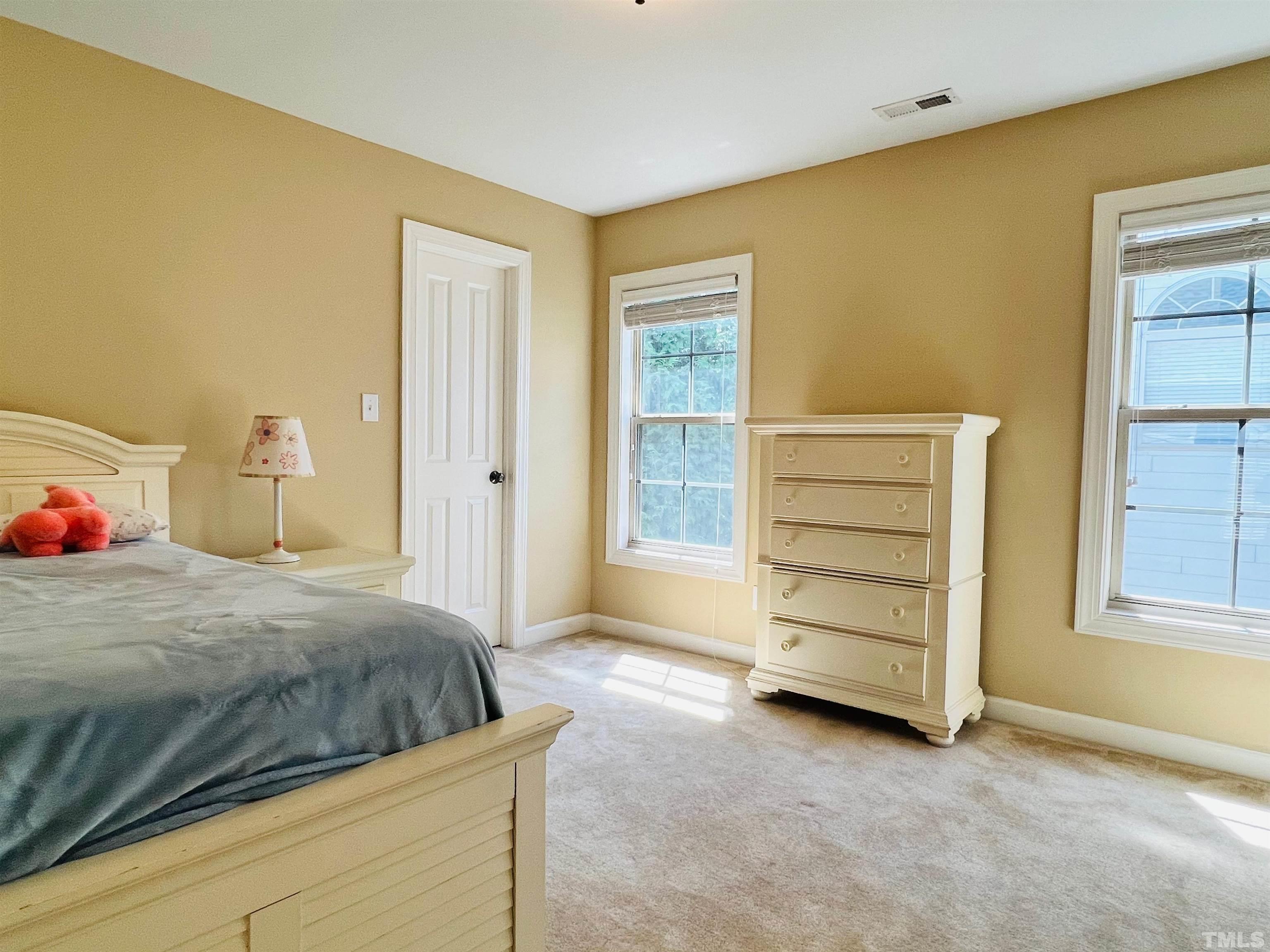 309 Parish House Road Cary, NC 27513 - Photo 15 of 33 a bedroom with a bed and a cabinets