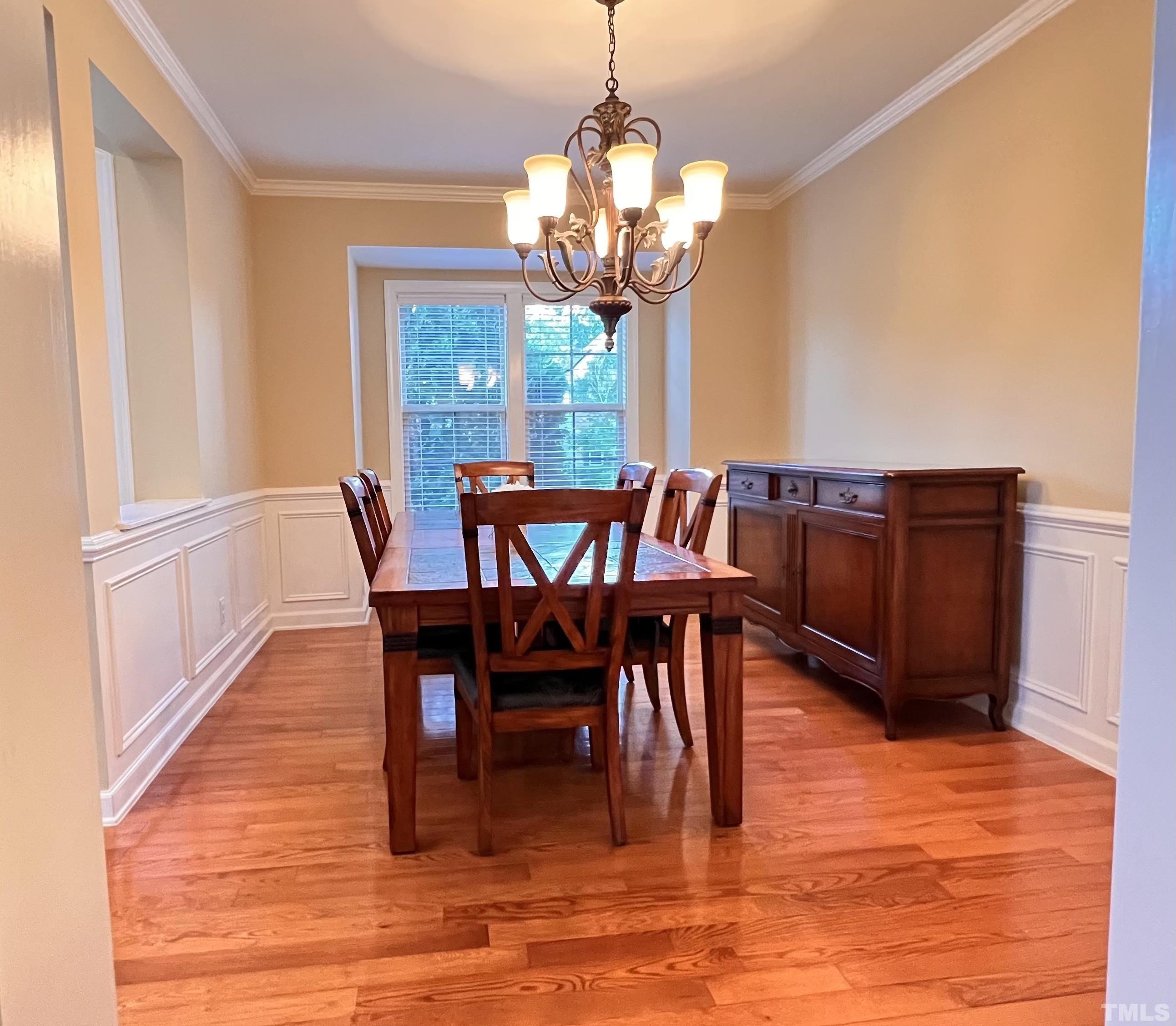309 Parish House Road Cary, NC 27513 - Photo 17 of 33 a dining room with furniture a chandelier and wooden floor