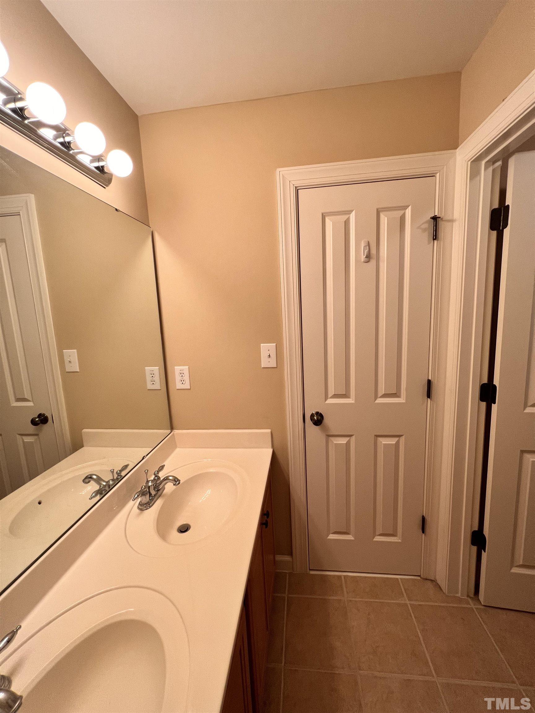 309 Parish House Road Cary, NC 27513 - Photo 18 of 33 a bathroom with a sink and a mirror