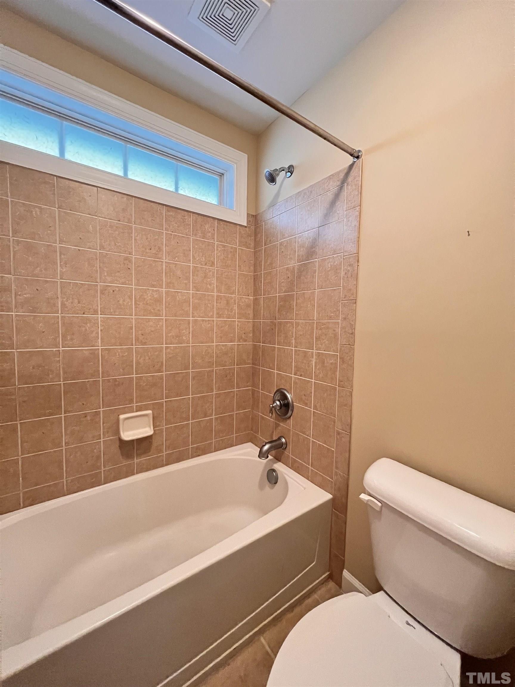 309 Parish House Road Cary, NC 27513 - Photo 19 of 33 a view of a bathroom with a tub and toilet
