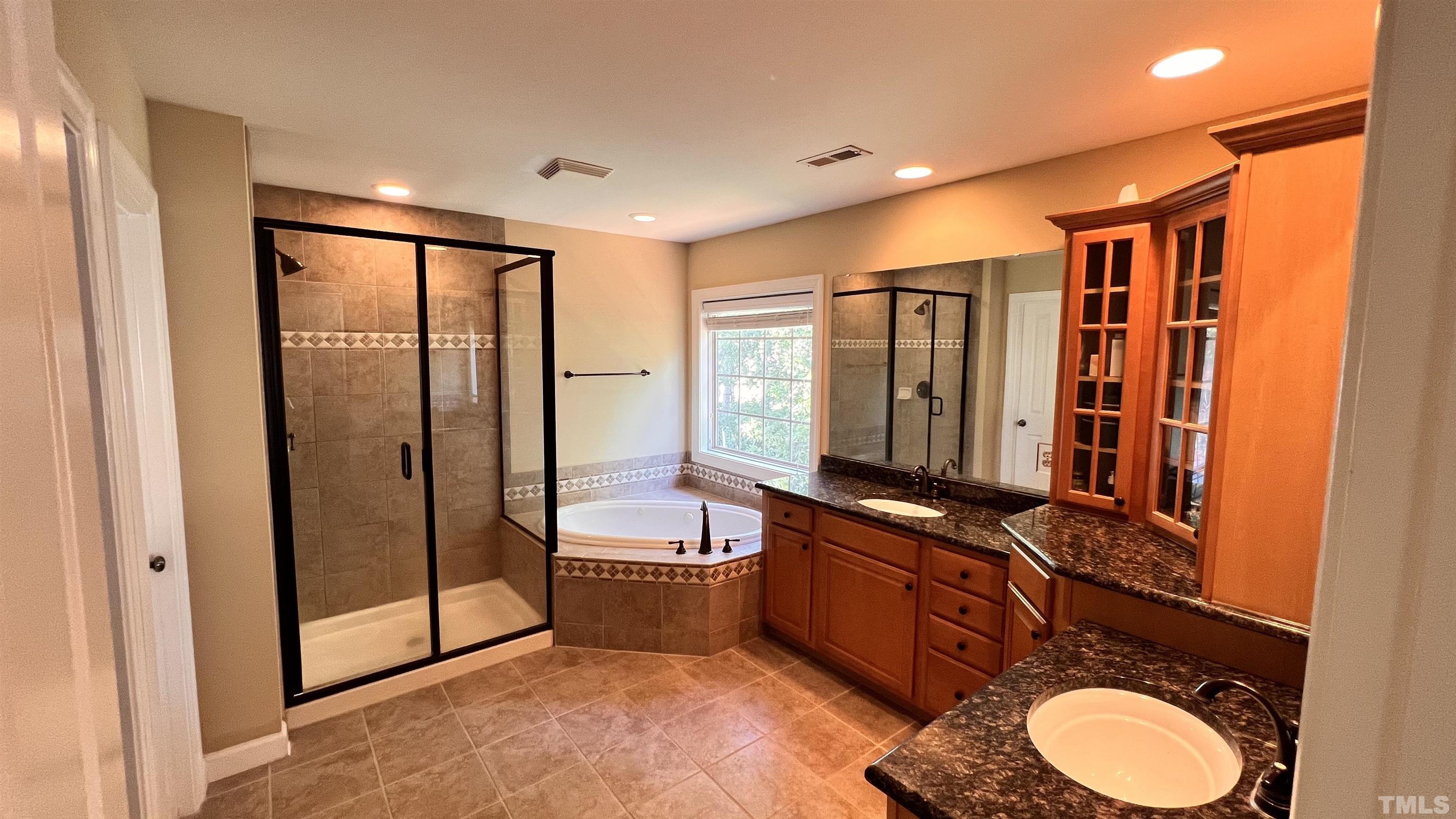 309 Parish House Road Cary, NC 27513 - Photo 24 of 33 a bathroom with a double vanity sink toilet mirror and shower