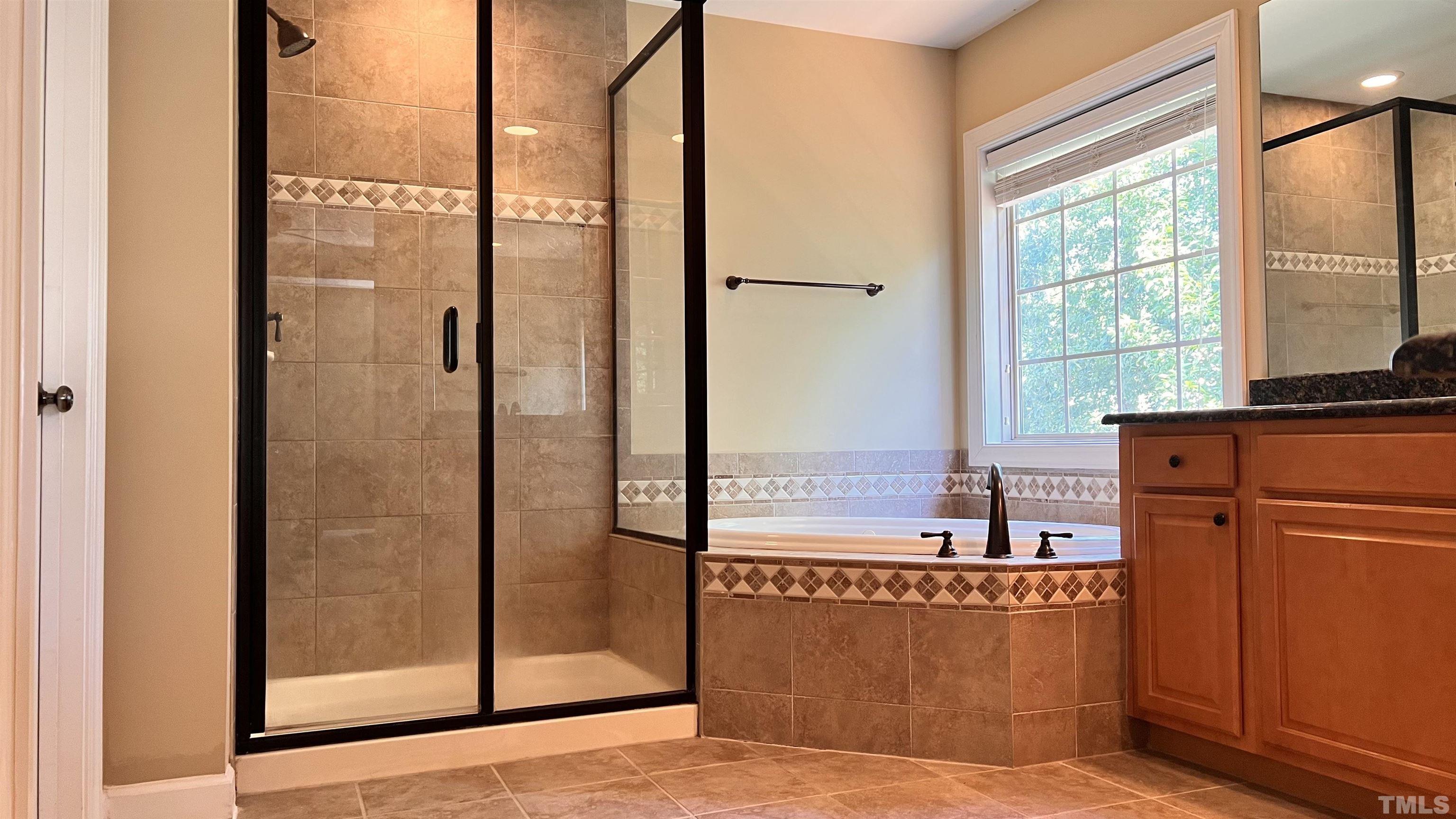309 Parish House Road Cary, NC 27513 - Photo 25 of 33 a view of a bathroom with a tub and a view of living room