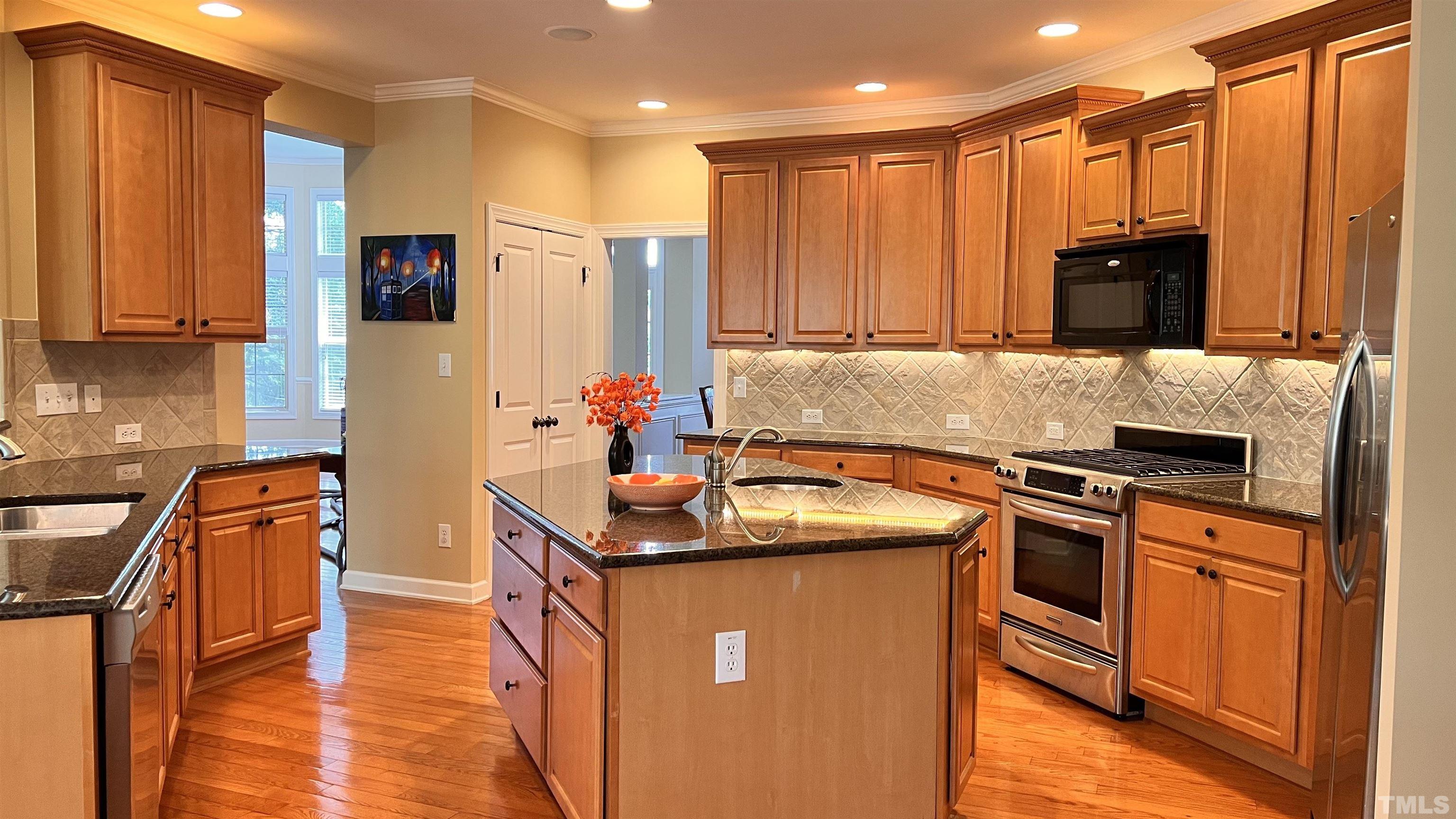 309 Parish House Road Cary, NC 27513 - Photo 7 of 33 a kitchen with stainless steel appliances granite countertop a sink stove and refrigerator