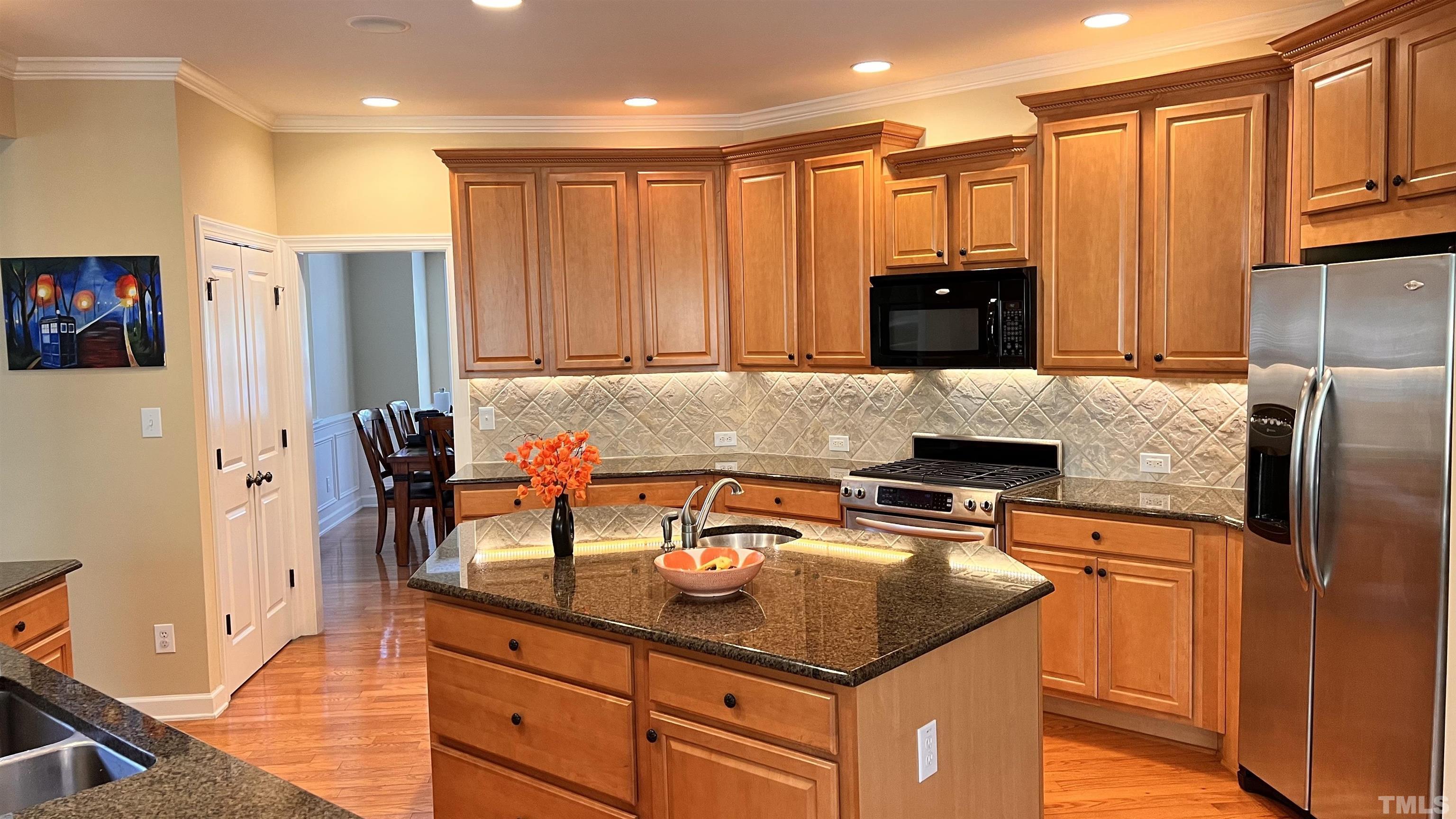 309 Parish House Road Cary, NC 27513 - Photo 8 of 33 a kitchen with stainless steel appliances granite countertop a refrigerator and a stove