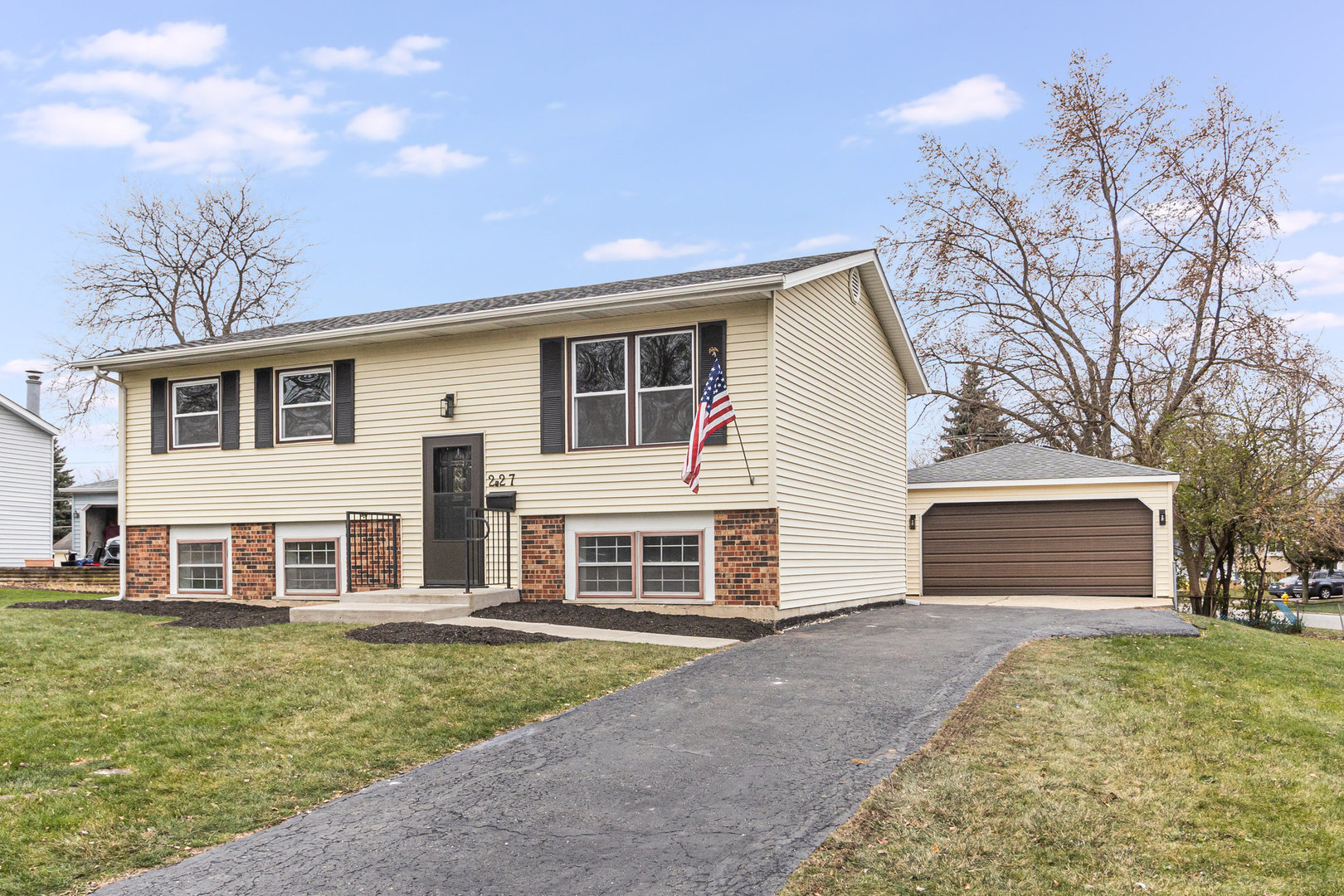 227 Hadleigh Road Bolingbrook, IL 60440 - Photo 2 of 19 a front view of a house with a yard and garage