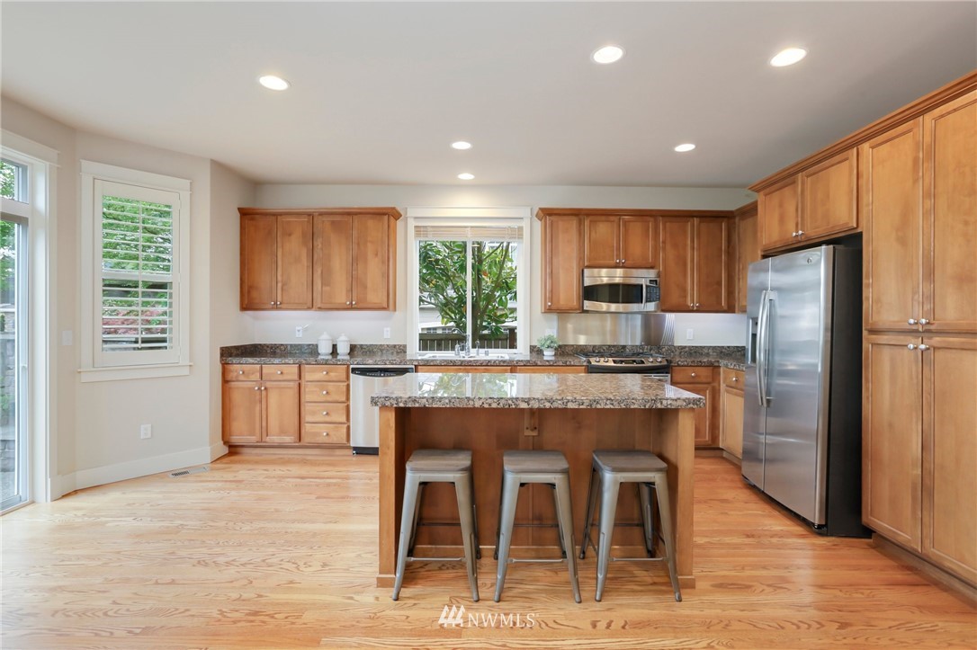 4014 167th Street Southeast Bothell, WA 98012 - Photo 16 of 39 a kitchen with stainless steel appliances granite countertop a refrigerator and a stove top oven