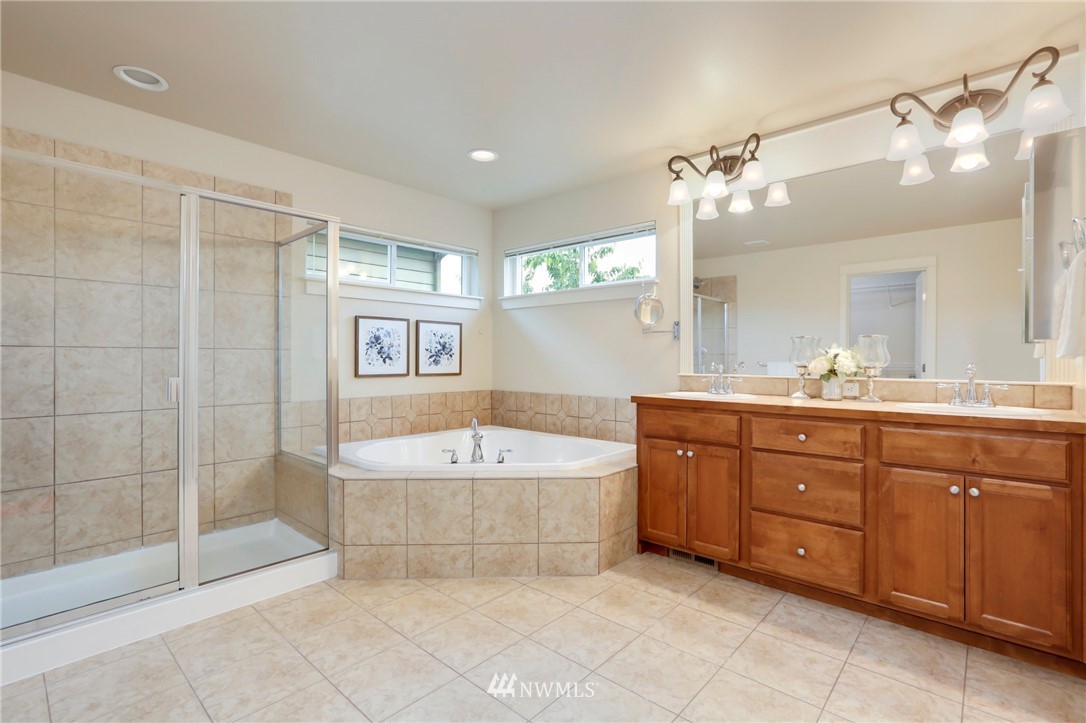 4014 167th Street Southeast Bothell, WA 98012 - Photo 24 of 39 a spacious bathroom with a tub sink shower and mirror