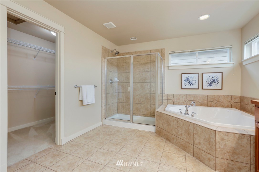 4014 167th Street Southeast Bothell, WA 98012 - Photo 25 of 39 a spacious bathroom with a tub shower and mirror