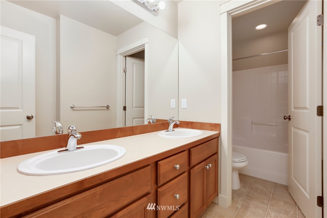 4014 167th Street Southeast Bothell, WA 98012 - Photo 30 of 39 a bathroom with a sink and a mirror