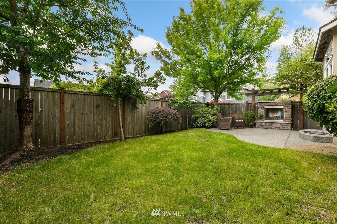 4014 167th Street Southeast Bothell, WA 98012 - Photo 34 of 39 a view of a backyard with large trees and a small yard