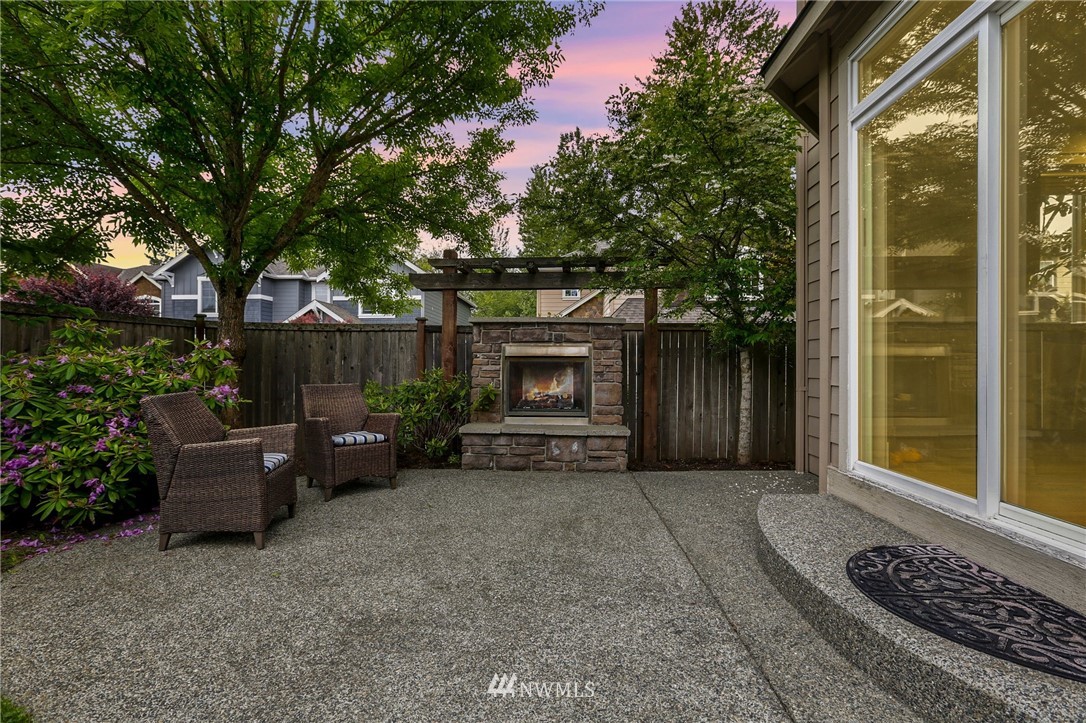 4014 167th Street Southeast Bothell, WA 98012 - Photo 36 of 39 a view of a couches and a fire pit in the patio next to a yard