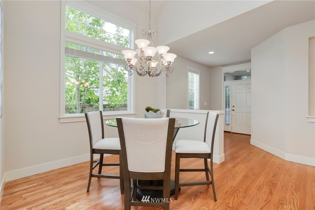 4014 167th Street Southeast Bothell, WA 98012 - Photo 6 of 39 a view of a dining room with furniture a chandelier and wooden floor