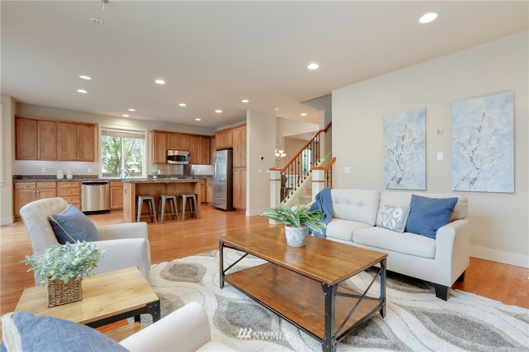 4014 167th Street Southeast Bothell, WA 98012 - Photo 10 of 39 a living room with furniture kitchen view and a wooden floor