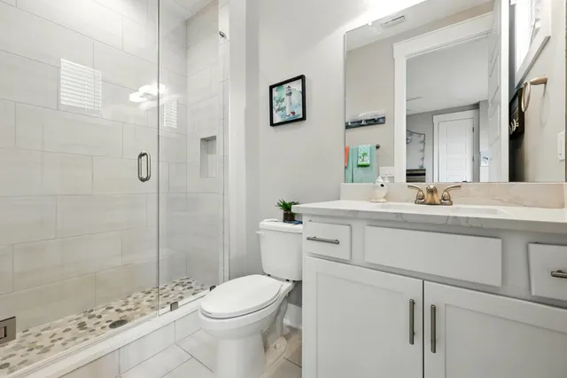 a kitchen with stainless steel appliances kitchen island a refrigerator and a stove top oven