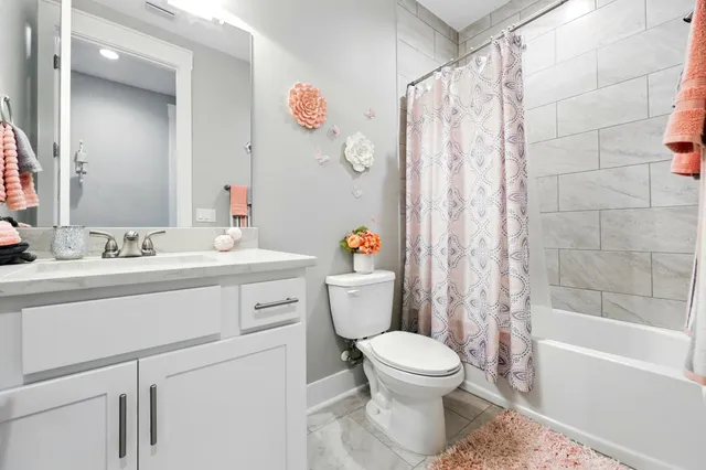 a view of a dining room with a table and chairs