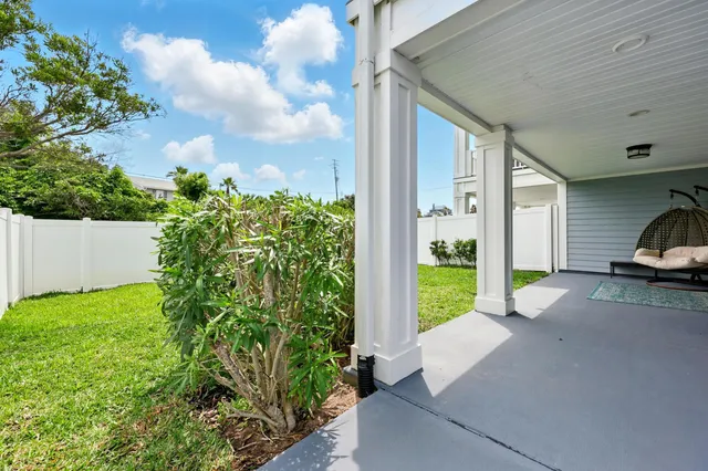a city view with tall buildings and couple of cars parked in front of it