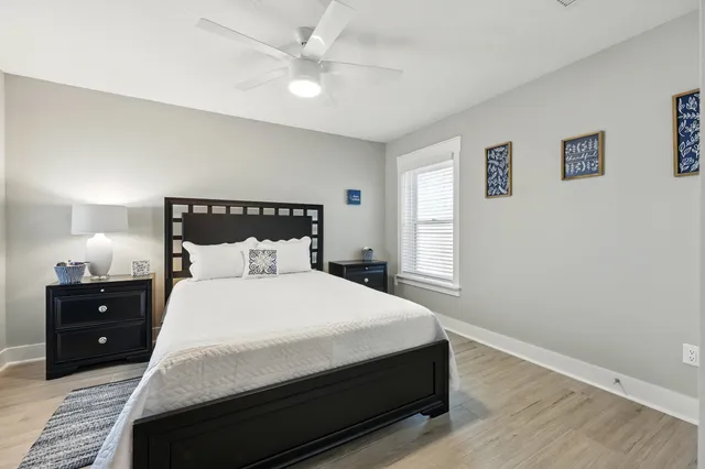 a view of a livingroom with wooden floor and a ceiling fan