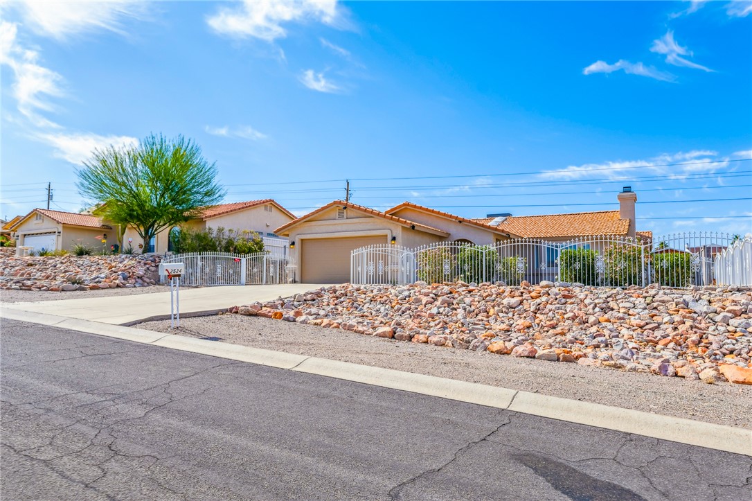 2524 South Ridge Avenue Bullhead City, AZ 86429 - Photo 5 of 64 Ranch-style home featuring concrete driveway, stucco siding, and a garage