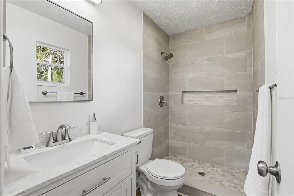 331 Northeast 2nd Street Williston, FL 32696 - Photo 24 of 29 a bathroom with a sink toilet a mirror and shower