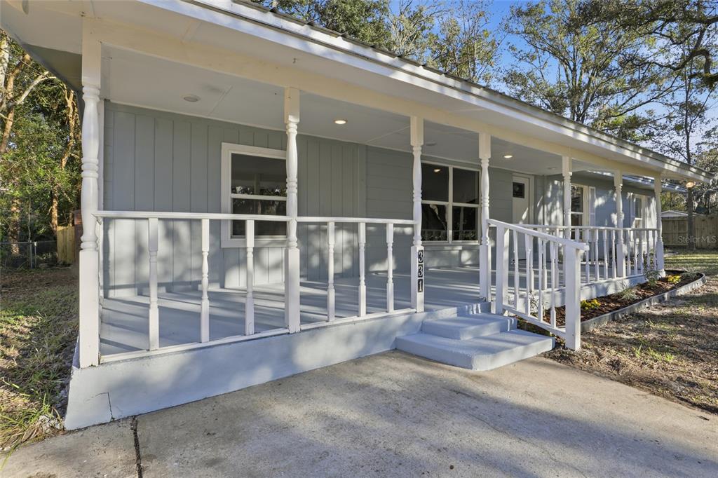 331 Northeast 2nd Street Williston, FL 32696 - Photo 4 of 29 a view of a house with a wooden deck and floor to ceiling window and wooden fence
