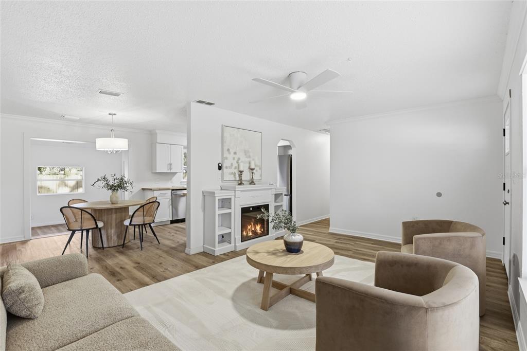 331 Northeast 2nd Street Williston, FL 32696 - Photo 8 of 29 a living room with furniture kitchen view and a chandelier